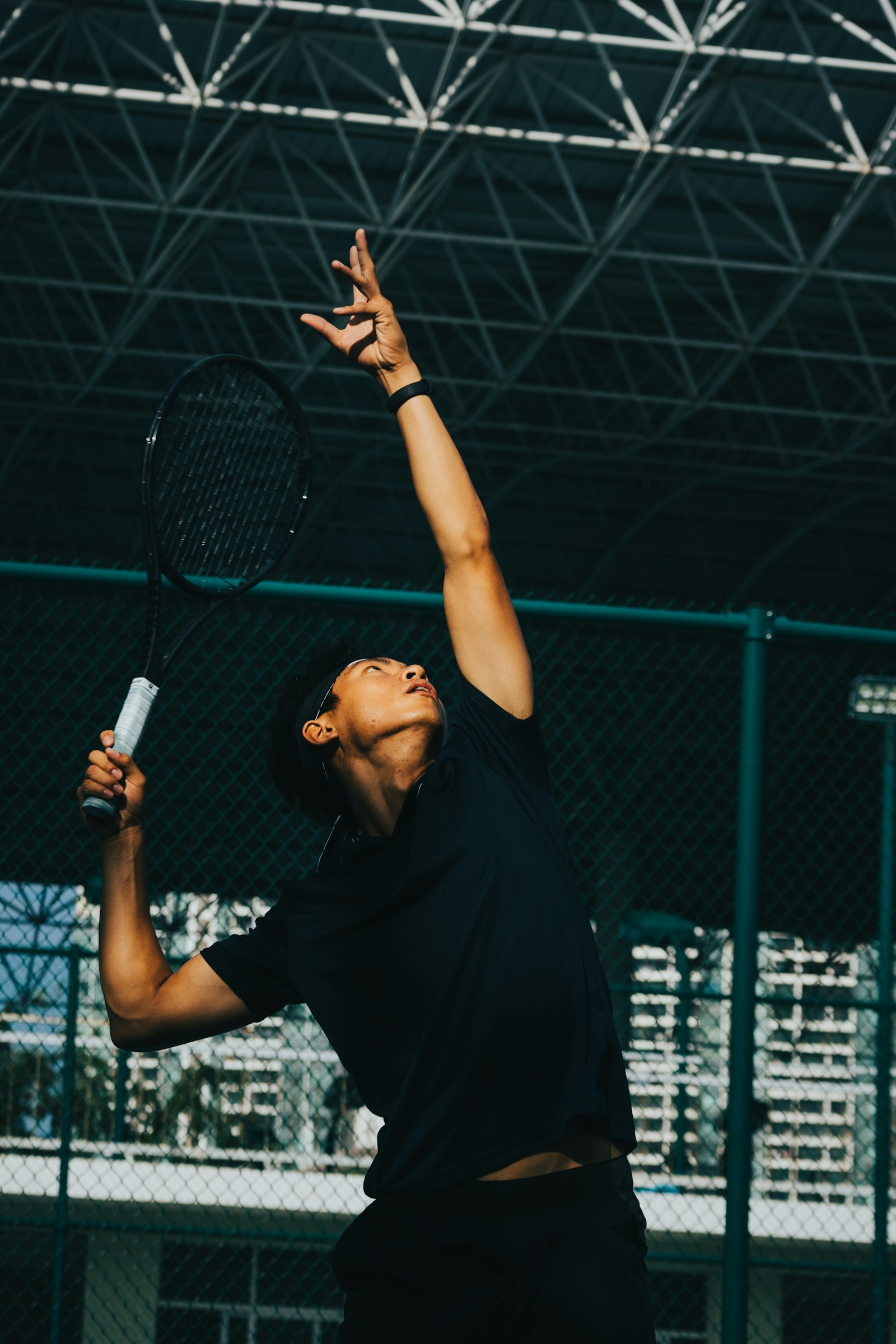 Kapalı kortta servis atan tenis oyuncusu